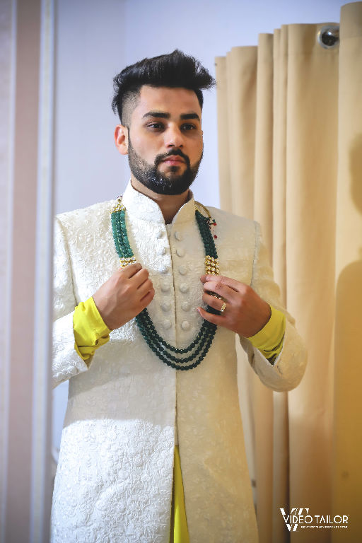 groom pose with accessories