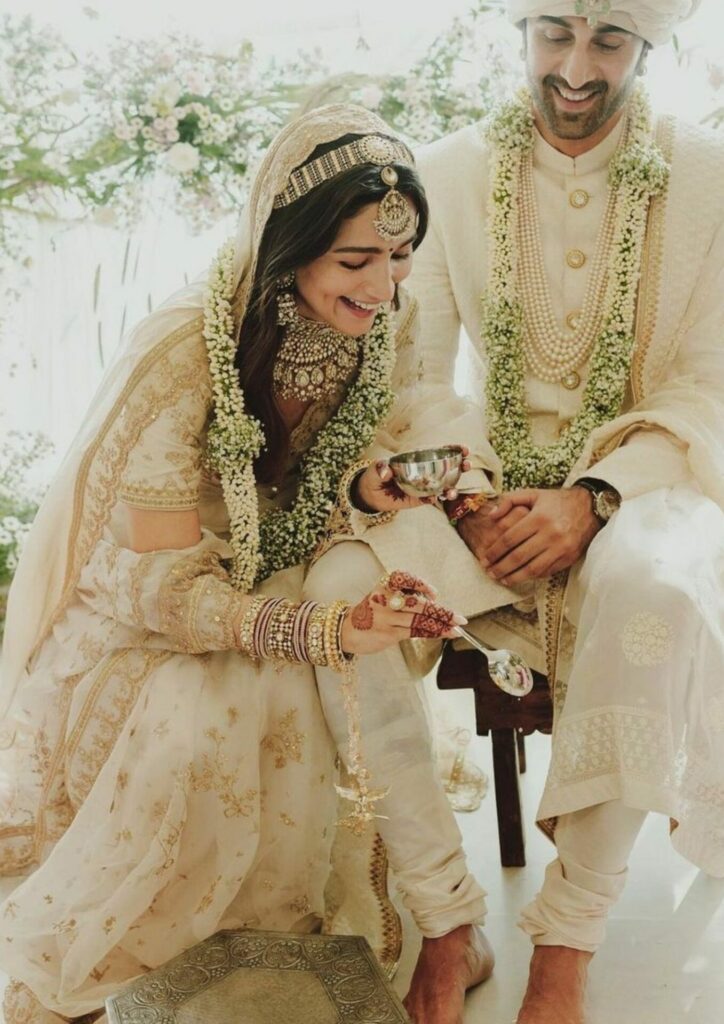 Premium Photo | Indian Bride and groom posing on their wedding Indian groom  in white Sherwani bride in dark red le