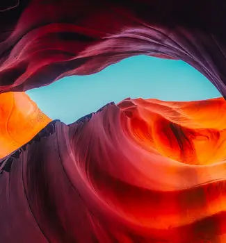 Colorful Arizona Dunes and arches during the day with contrasting waves and shadows.