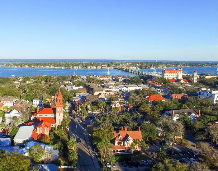 Overlooking Saint Augustine City in Florida on a sunny day with rivers, bridges, and red buildings.