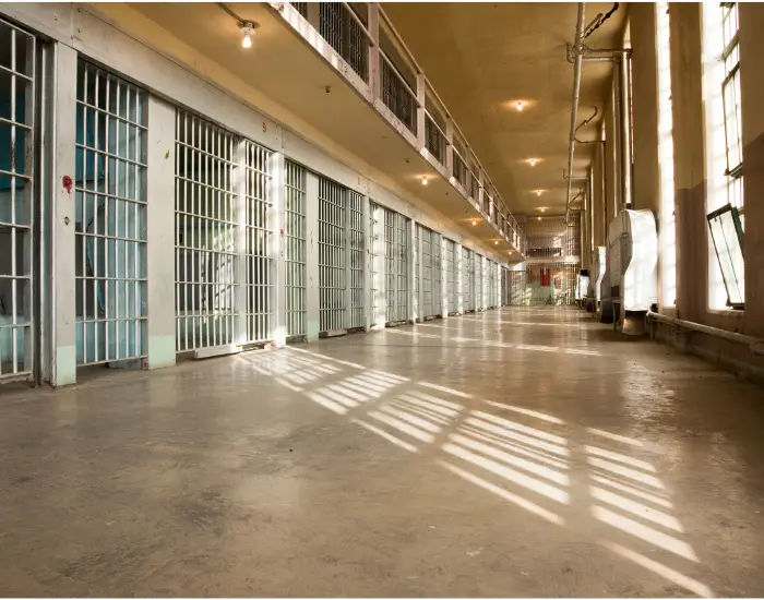 Indiana Rotary Jail Museum with steel barred cells leading down a hall with light shining through the window.