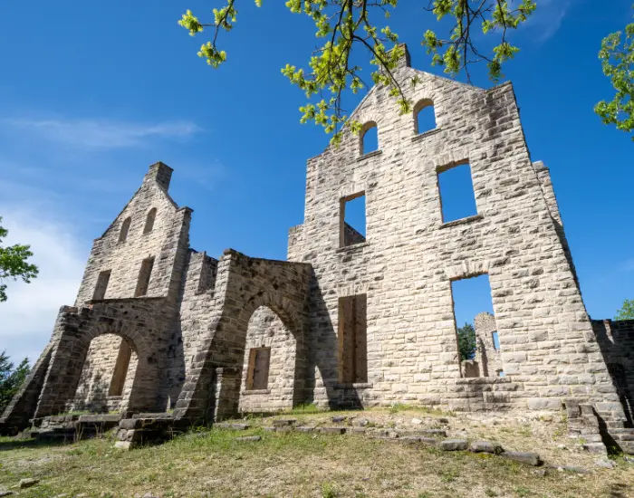 Castle ruins in Ha Ha Tonka State Park, Missouri close to Lake of the Ozarks on a summer day with clear skies.