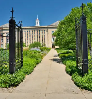 Street view of gates into the University of Nebraska in Lincoln, Nebraska on a sunny day.