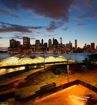Promenade in Brooklyn Heights aerial view with New York City skyline at night.
