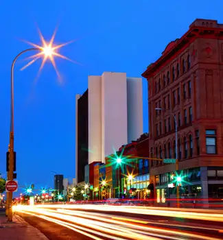 Fargo, North Dakota city streets lined with red and white buildings with a mix of urban and modern appeal at night with light painting.