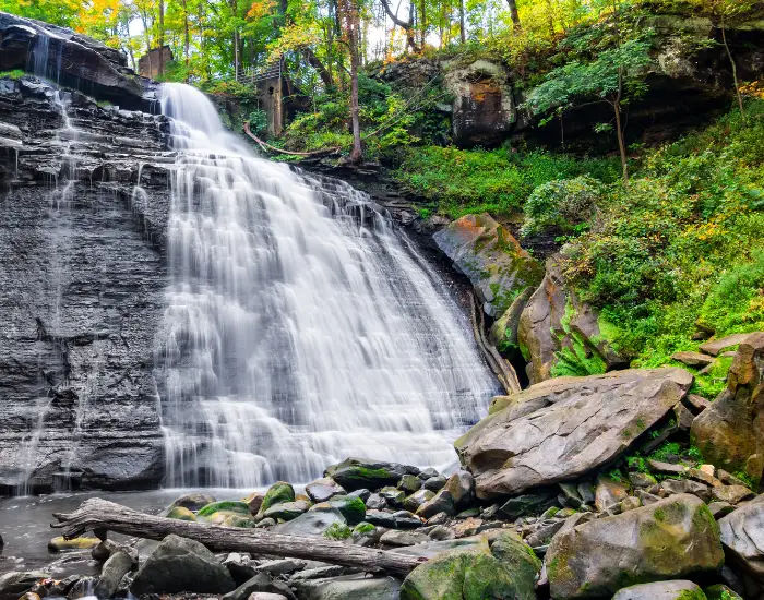 Cuyahoga Valley National State Park in Ohio with Brandywine Falls streaming down different levels of rocks in a forest.