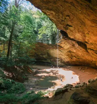 Water streaming down the Ash Caves in Hocking Hills State Park, Ohio on a sunny day.