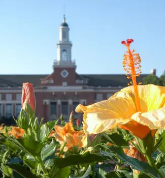 Library of Oklahoma State University in Stillwater with orange flowers in the foreground in a sunny day.