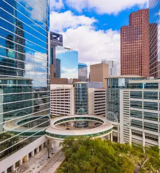 Houston, Texas downtown cityscape with circular buildings and glass mirror walls reflecting the sky.