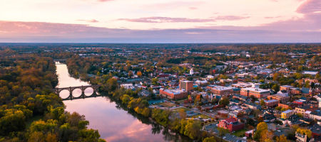 Fredericksburg, Virginia aerial view with Rappahannock river flowing by the city at sundown.