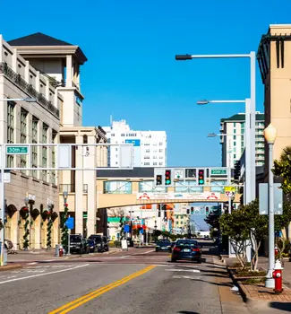 Virginia beach oceanfront city center with buildings, roads, and a bridge between two buildings for shopping access.