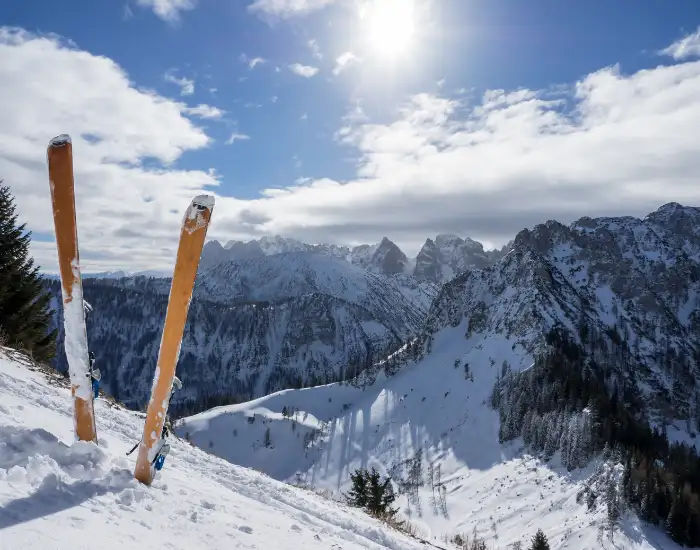 View of the Grand Teton mountain range in Wyoming with three snow-capped mountains behind a thick bed of fluffy snow.