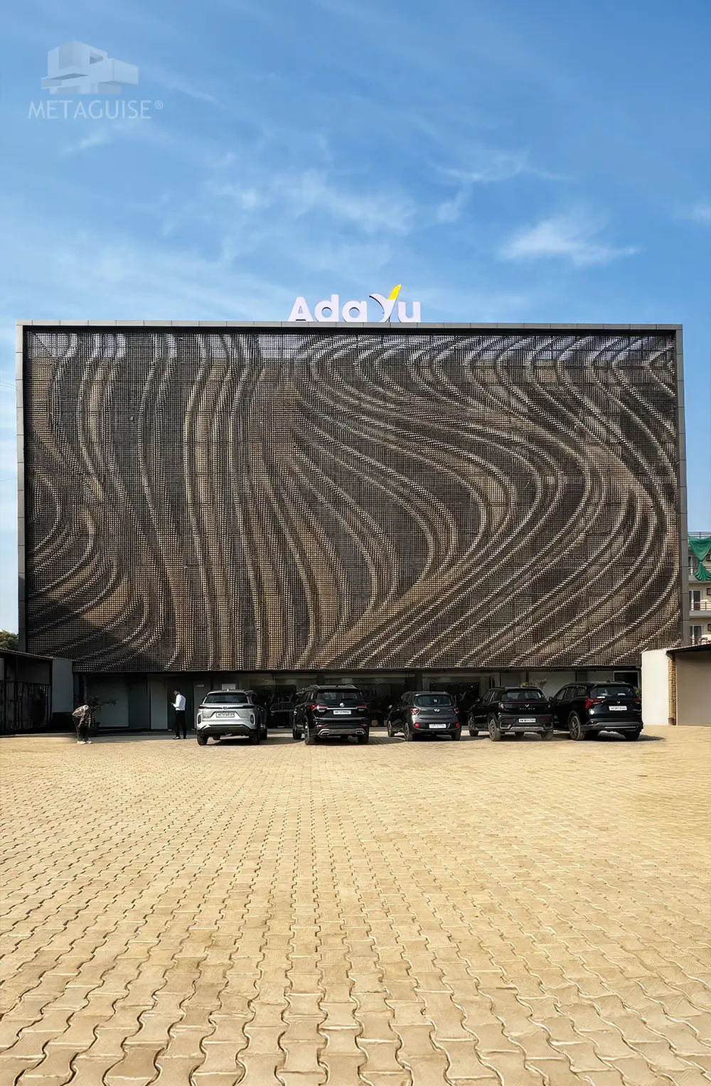 Large institutional building elevation with artistic facade mural and modern architectural cladding design developed by Metaguise