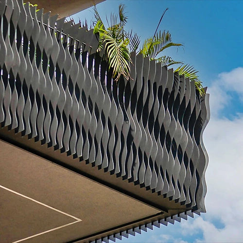 Custom-shaped golden MetaFins forming a shimmering parametric facade.