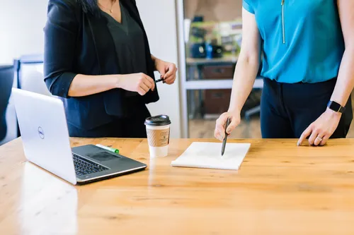 Two women looking at paper