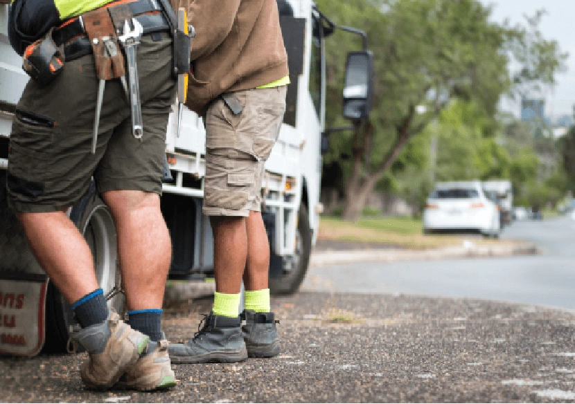 Picture of 2 Tradies getting tools from their truck