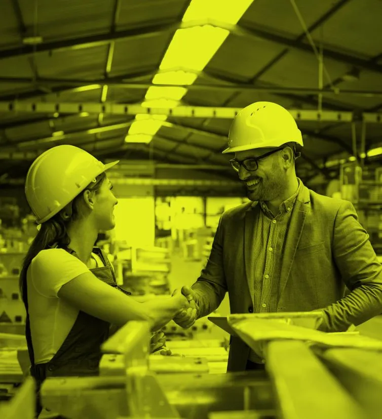 Shaking hands inside a factory 