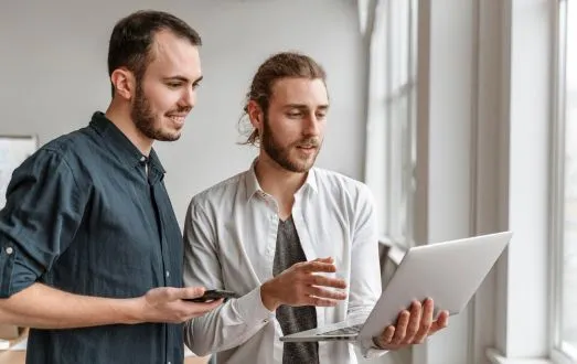 Two businessmen looking at work on a laptop