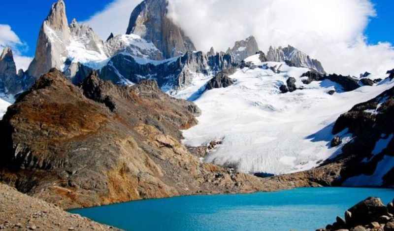 mountain covered with ice in front of lake