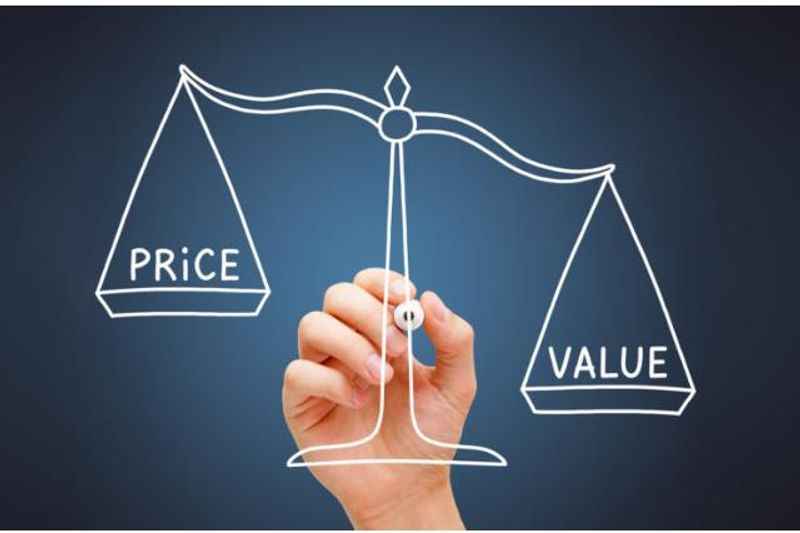 a hand drawing a scale of price and value of product