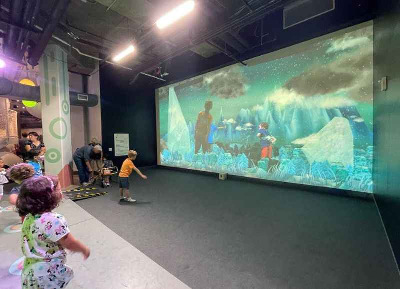 a group of children playing in a large room