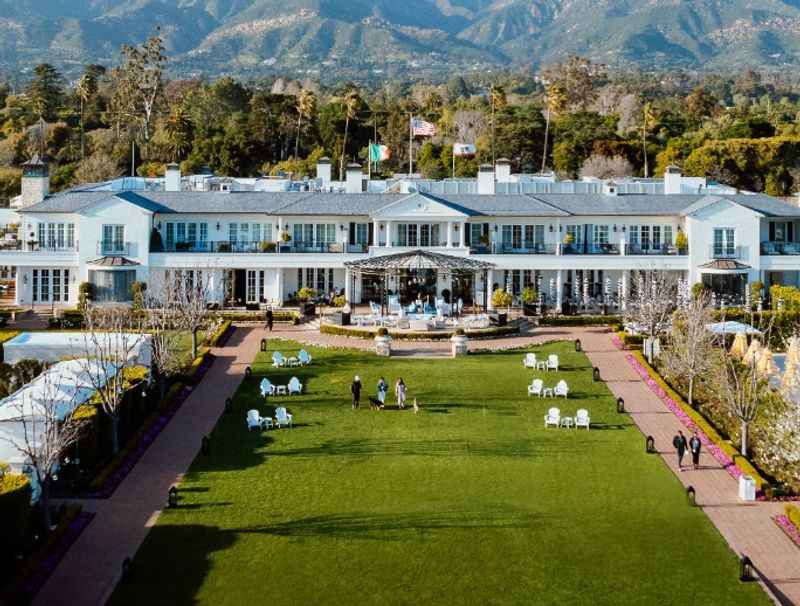 facade of the resort with wide green grass in front