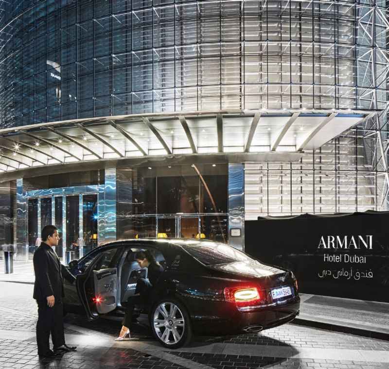 a man standing next to a car outside a building