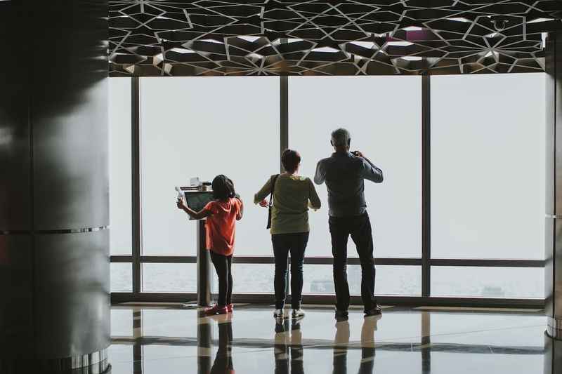 a family looking out the window at the city