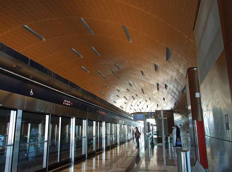 a long hallway with a ceiling of wood and metal