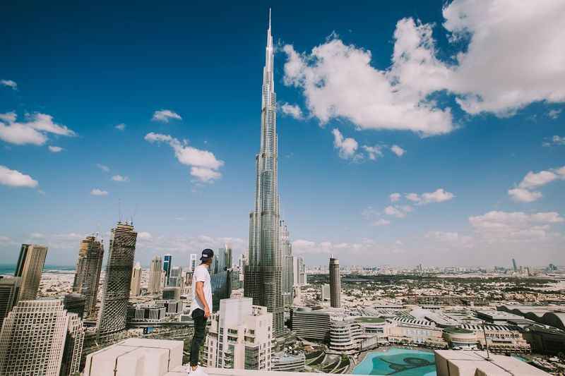 a man standing on top of a building looking at the city