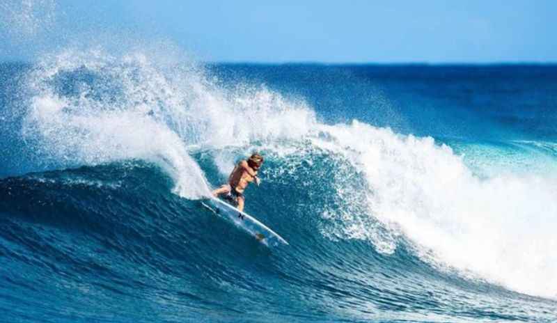 a surfer rides a wave in the ocean