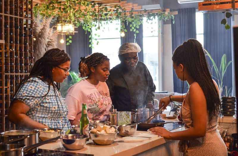 a group of people cooking in a kitchen