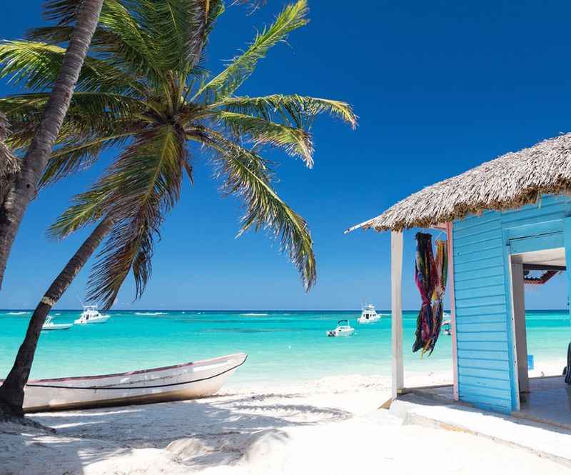 a beach hut with a thatched roof