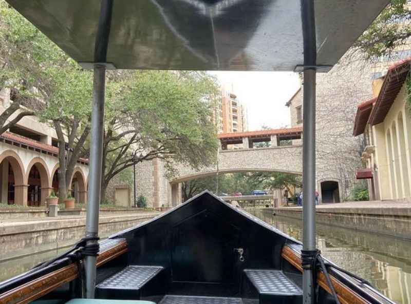 a boat traveling down a canal in the middle of a city