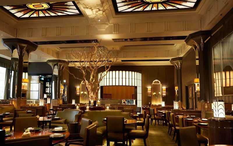 large dining room with tables and chairs with mood lighting