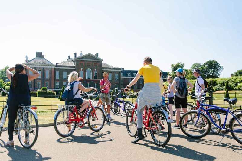 group of people on bikes with building in background