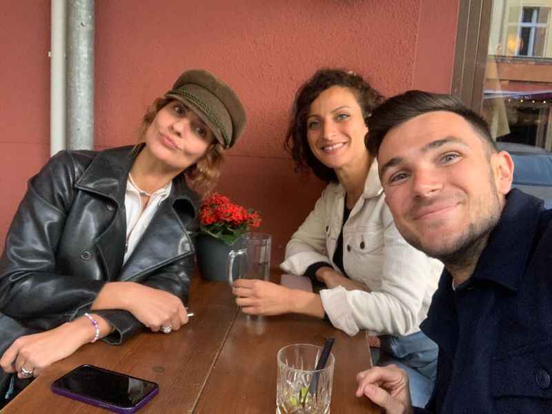 a man and two women with glasses on their tables