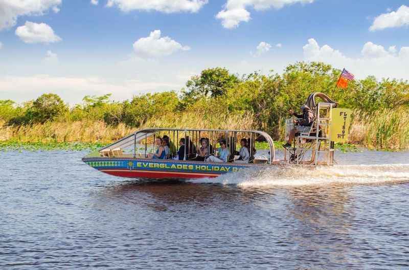 a boat traveling down the river with people on it