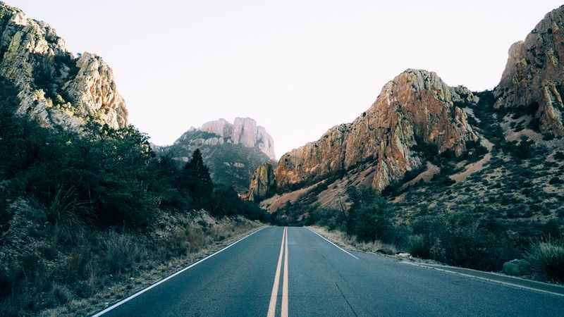 a road with mountains in the background