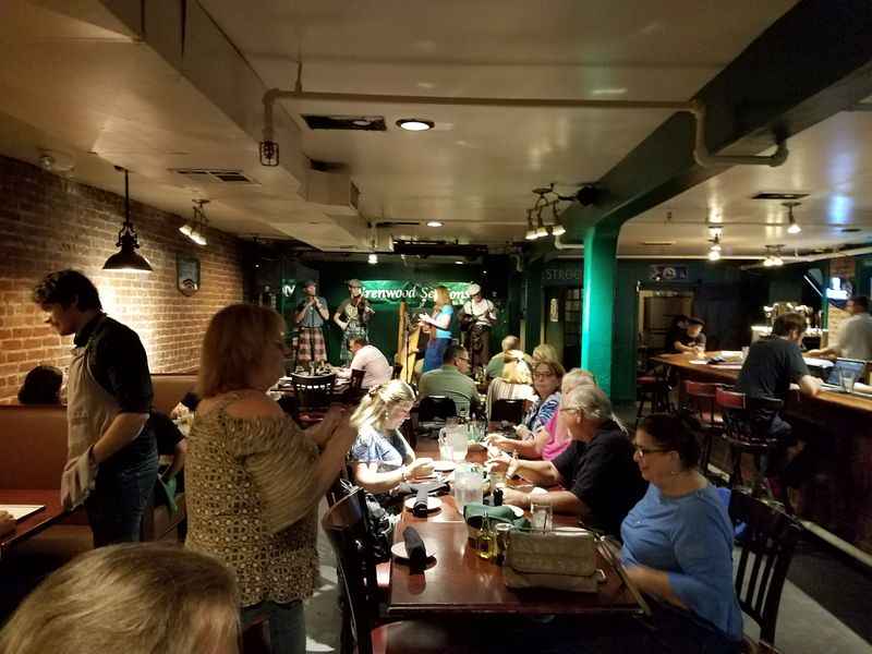 a group of people sitting at a table in a restaurant