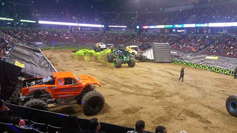 a monster truck is in the middle of a dirt pit