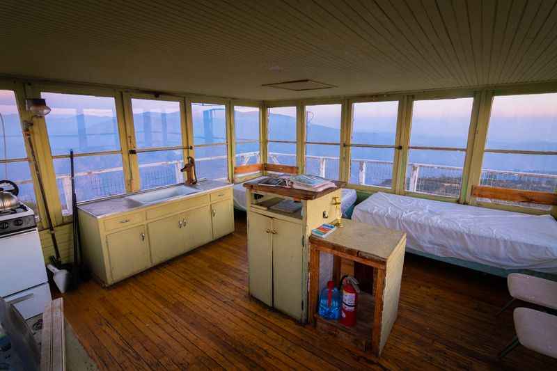 a kitchen and a bed in a room