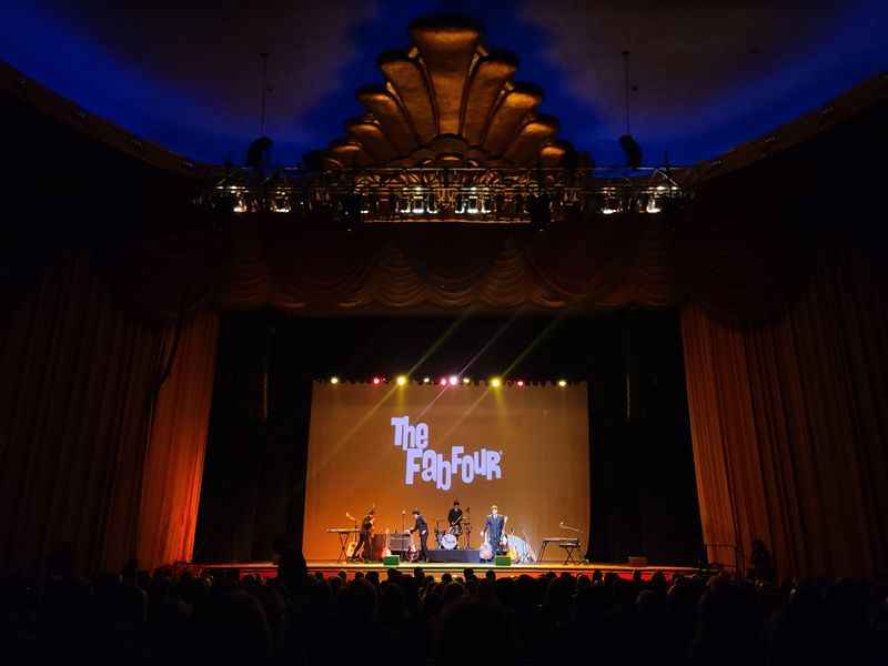 group of people on the stage with lighting