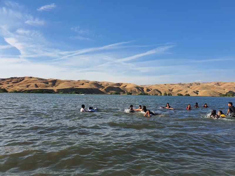 a group of people swimming in a lake