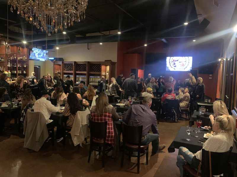 a group of people sitting at tables in a restaurant