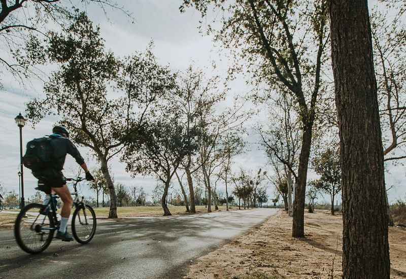 man biking down the road