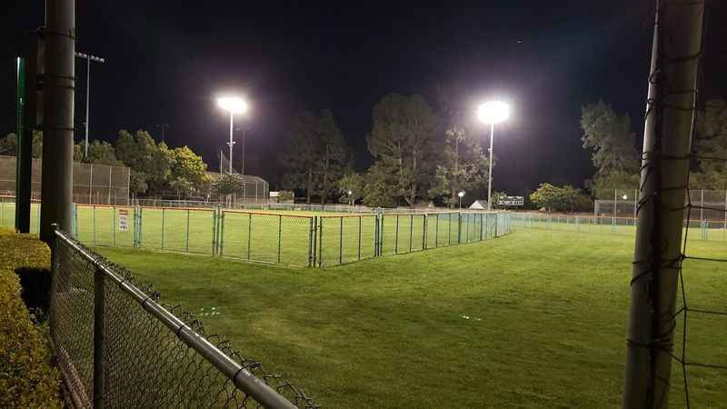 a soccer field at night with lights on