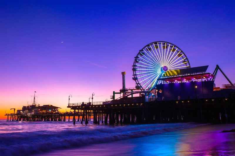 a beach with a ferris in the background