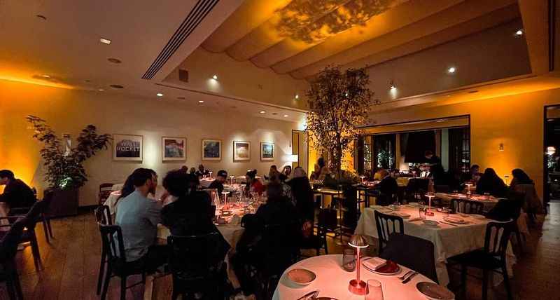 a restaurant with people sitting at tables and eating