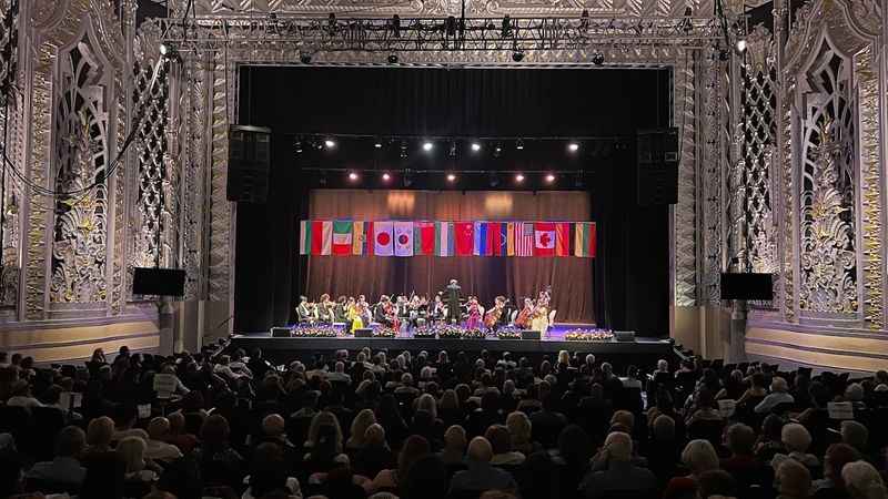 a large crowd of people sitting on a stage